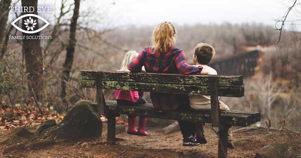 family sitting on a bench