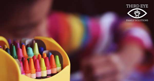 girl coloring with crayons